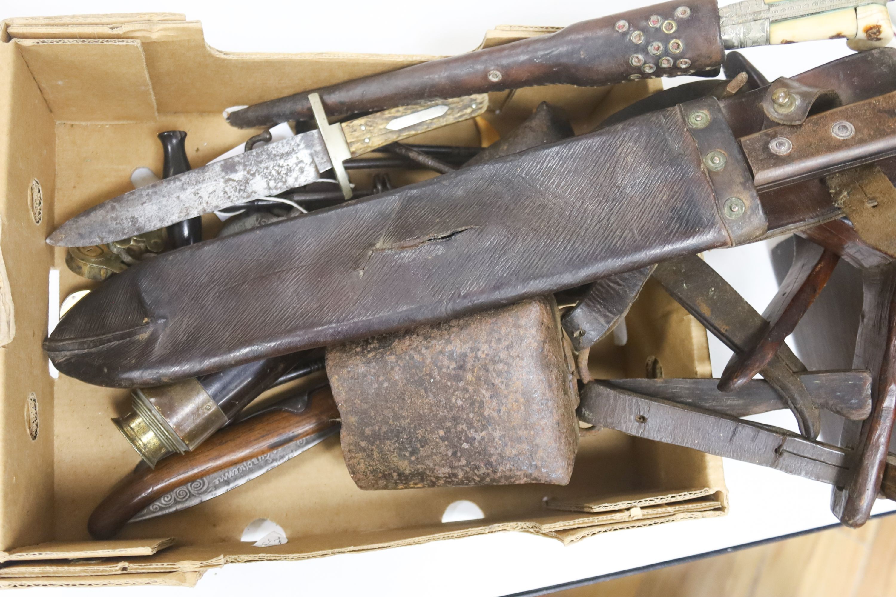 A 19th century tooth extractor, boot pulls, military knives, telescope, leather ledger and iron kettle